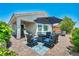Outdoor patio with pavers, an umbrella, and seating area with a view of desert vegetation and a backyard fence at 7029 Bocaire Dr, Las Vegas, NV 89131