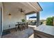 Outdoor covered patio with high table and chairs as well as a seating area with comfortable chairs and shade umbrella at 7029 Bocaire Dr, Las Vegas, NV 89131