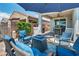 Comfortable outdoor patio with fireplace, pavers and outdoor furniture and an umbrella that provides shade at 7029 Bocaire Dr, Las Vegas, NV 89131