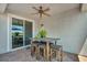 Covered patio featuring a dining area, ceiling fan, and sliding glass door at 7029 Bocaire Dr, Las Vegas, NV 89131
