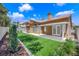 Fully fenced backyard featuring manicured lawn and covered patio at 7813 Riviera Beach Dr, Las Vegas, NV 89128