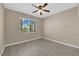 Comfortable bedroom featuring a large window with a view of the landscaped yard at 7813 Riviera Beach Dr, Las Vegas, NV 89128