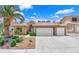 Inviting single-story home featuring a three-car garage and desert landscaping at 7813 Riviera Beach Dr, Las Vegas, NV 89128