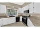 Bright kitchen features granite counters, white cabinets, and stainless steel appliances at 7813 Riviera Beach Dr, Las Vegas, NV 89128