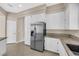 Kitchen showcasing a stainless steel refrigerator and white cabinets at 7813 Riviera Beach Dr, Las Vegas, NV 89128