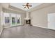 An inviting living room with a ceiling fan, fireplace, french doors to the backyard, and light flooring at 7813 Riviera Beach Dr, Las Vegas, NV 89128