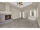 Spacious living room featuring a fireplace, ceiling fan, light flooring, and an open floor plan at 7813 Riviera Beach Dr, Las Vegas, NV 89128