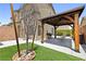 Backyard with a gazebo, lawn, grill and hardscape including a low rock wall at 7868 Territorial St, Las Vegas, NV 89149