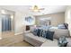 Comfortable bedroom with a large couch, bed, ceiling fan, and natural light at 7868 Territorial St, Las Vegas, NV 89149