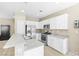 Bright kitchen featuring stainless steel appliances and white cabinets at 7868 Territorial St, Las Vegas, NV 89149