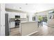 Modern kitchen with white cabinets, stainless appliances, and a dining area at 7868 Territorial St, Las Vegas, NV 89149