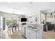 Eat-in kitchen featuring laminate floors, white cabinetry and stainless appliances at 7868 Territorial St, Las Vegas, NV 89149