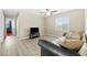 Living room with hardwood floors, a black tv, a window and a grey couch with throw pillows at 7868 Territorial St, Las Vegas, NV 89149