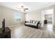 Living room features a window, couch, wood-look floors, and a view into the room at 7868 Territorial St, Las Vegas, NV 89149
