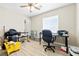 Office features a ceiling fan, a desk, a black office chair, and laminate wood floors at 7868 Territorial St, Las Vegas, NV 89149