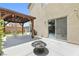 Cozy backyard patio with a pergola, fire pit, grill, and sliding glass doors for seamless indoor-outdoor living at 7868 Territorial St, Las Vegas, NV 89149
