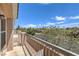 Charming balcony with view of flowering trees and blue sky above street at 8775 Traveling Breeze Ave # 102, Las Vegas, NV 89178