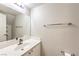 Half bathroom features a large mirror, modern fixtures, and neutral color palette at 8775 Traveling Breeze Ave # 102, Las Vegas, NV 89178