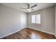 Bright bedroom featuring hardwood floors, ceiling fan, and large closet at 8775 Traveling Breeze Ave # 102, Las Vegas, NV 89178
