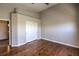 Bedroom with hardwood floors, neutral walls, and a closet with sliding doors at 8775 Traveling Breeze Ave # 102, Las Vegas, NV 89178