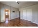 Spacious bedroom features wood floors, closet with sliding doors, and neutral paint at 8775 Traveling Breeze Ave # 102, Las Vegas, NV 89178