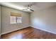 Well-lit bedroom with ceiling fan, wood floors and ample natural light from window at 8775 Traveling Breeze Ave # 102, Las Vegas, NV 89178