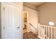 Hallway view leading to a carpeted staircase and a glimpse into the adjacent bathroom at 8775 Traveling Breeze Ave # 102, Las Vegas, NV 89178