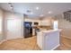 Well-lit kitchen featuring white cabinets, black appliances, and bar-style seating at 8775 Traveling Breeze Ave # 102, Las Vegas, NV 89178
