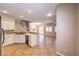 Bright, open kitchen with white cabinets and tile floors extending into the living area at 8775 Traveling Breeze Ave # 102, Las Vegas, NV 89178