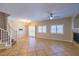 Open living area with tile flooring, a cozy fireplace, and staircase to the upper level at 8775 Traveling Breeze Ave # 102, Las Vegas, NV 89178