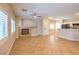 Bright open layout with tile flooring, fireplace, kitchen bar, and plenty of natural light at 8775 Traveling Breeze Ave # 102, Las Vegas, NV 89178