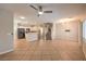 Open living space with tile floors, white kitchen, staircase, and modern lighting at 8775 Traveling Breeze Ave # 102, Las Vegas, NV 89178