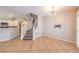 Inviting living space featuring stairs, modern light fixture, and open access to the kitchen at 8775 Traveling Breeze Ave # 102, Las Vegas, NV 89178