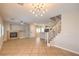 Open-concept living space with tile floors, fireplace, staircase, and access to the kitchen at 8775 Traveling Breeze Ave # 102, Las Vegas, NV 89178