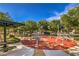 Community playground features cushioned ground, shade coverings, picnic tables, and exercise equipment at 8775 Traveling Breeze Ave # 102, Las Vegas, NV 89178