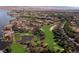 Aerial view of a golf course, lake, and residential homes. Lush fairways and community design at 9 Rue Grimaldi Way, Henderson, NV 89011