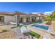 Beautiful backyard with a pool, spa, and lounge area for outdoor relaxation at 9 Rue Grimaldi Way, Henderson, NV 89011