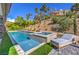 Outdoor space with pool, spa, and hillside landscaping with lounge chair at 9 Rue Grimaldi Way, Henderson, NV 89011