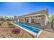 A luxury backyard featuring long pool, lounge area, and patio with stone pillars at 9 Rue Grimaldi Way, Henderson, NV 89011