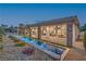 Stunning backyard featuring a long pool, beautiful landscaping, and a covered patio with large windows offering seamless indoor-outdoor living at 9 Rue Grimaldi Way, Henderson, NV 89011