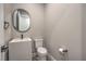 Modern powder room with a floating sink and round mirror at 9 Rue Grimaldi Way, Henderson, NV 89011