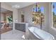 Luxurious bathroom featuring a freestanding tub and a view overlooking the hillside at 9 Rue Grimaldi Way, Henderson, NV 89011