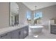 Elegant bathroom featuring a freestanding tub, marble floors, and mountain views at 9 Rue Grimaldi Way, Henderson, NV 89011