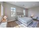 Bright bedroom with wood floors, rug, large windows, and sitting area bathed in sunlight at 9 Rue Grimaldi Way, Henderson, NV 89011