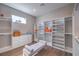 A bright and open walk-in closet with ample storage, drawers and bench seat at 9 Rue Grimaldi Way, Henderson, NV 89011
