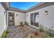 Charming courtyard with stone pathway, plants, and exterior lighting at 9 Rue Grimaldi Way, Henderson, NV 89011
