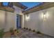 Exterior shot of a home entryway with desert landscaping and modern sconces at 9 Rue Grimaldi Way, Henderson, NV 89011