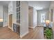 Bright entryway featuring wood-look floors, gray cabinetry, and seamless access to modern kitchen at 9 Rue Grimaldi Way, Henderson, NV 89011