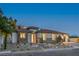 Charming home exterior with a tile roof, stone accents, and well-maintained landscaping at 9 Rue Grimaldi Way, Henderson, NV 89011