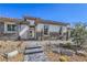 Striking exterior with stone accents, tile roof, and manicured desert landscape at 9 Rue Grimaldi Way, Henderson, NV 89011